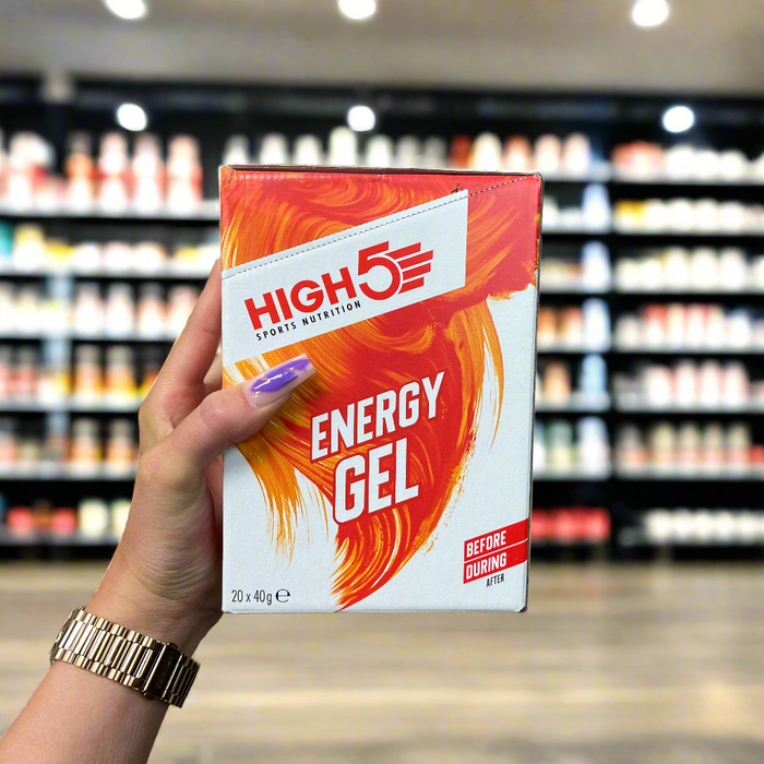 Close-up of HIGH5 Energy Gel 20x40g held up inside My Supplement Shop, clearly showing the front label in a Sports Nutrition setting.
