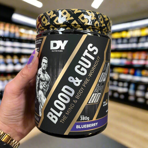 Close-up of Dorian Yates DY Nutrition Blood And Guts 380g) held up inside My Supplement Shop, clearly showing the front label in a Sports Nutrition setting.