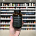 Close-up of (Kiki Health Activated Charcoal Powder 70g) held up inside My Supplement Shop, clearly showing the front label in a Sports Nutrition setting.